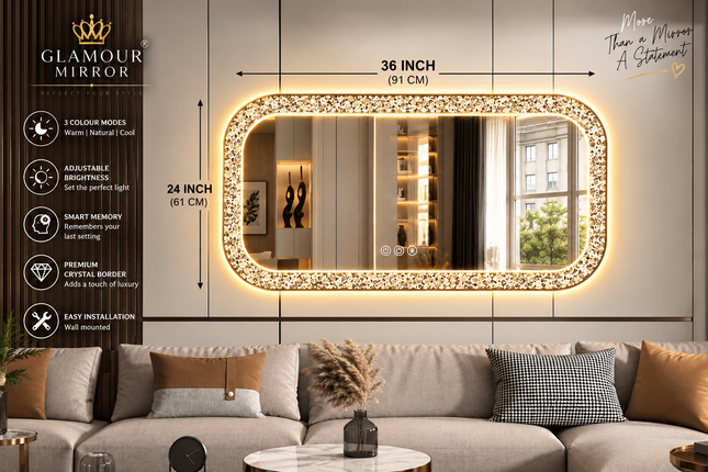 A large rectangular Glamour Mirror with a sparkling gold border and warm LED lighting, shown mounted on a wall above a sofa in a modern living room. The image includes dimension callouts of 36 inches by 24 inches and a left-side feature list for the mirror.